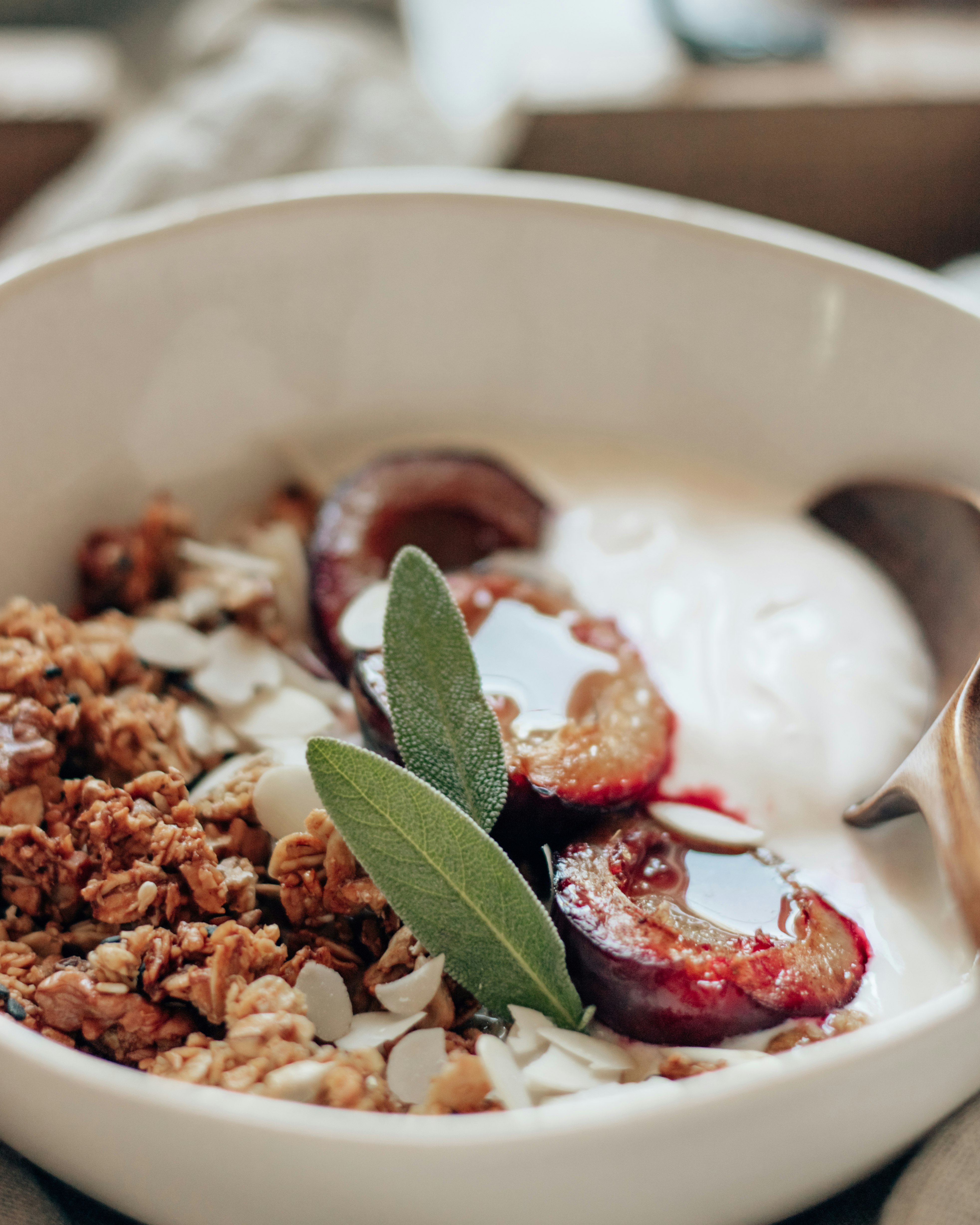 sliced strawberry and green leaf on white ceramic bowl